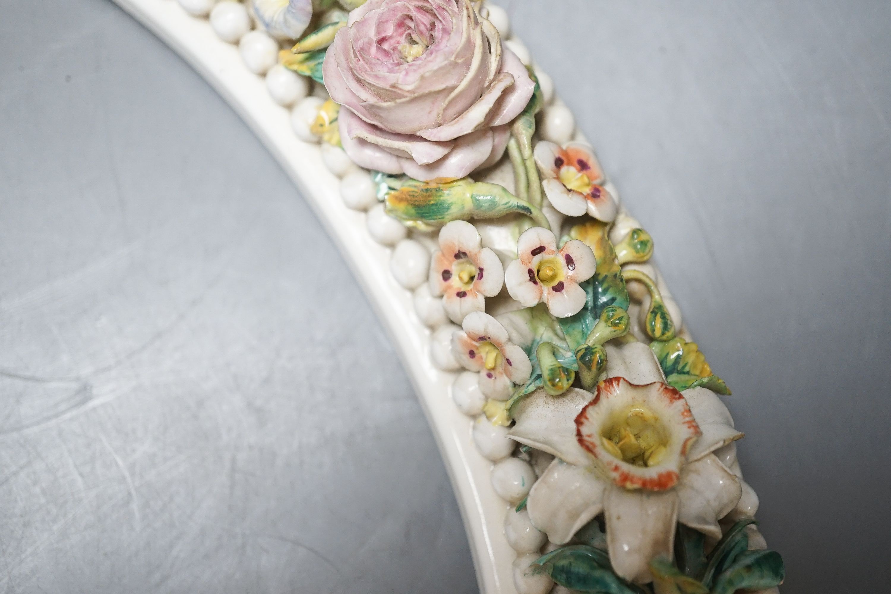 A 19th century English porcelain floral encrusted oval frame 32cm